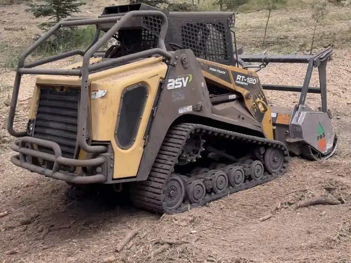 Land clearing in Kittredge, CO: skid steer with a forestry mulcher on a mountain clearing job