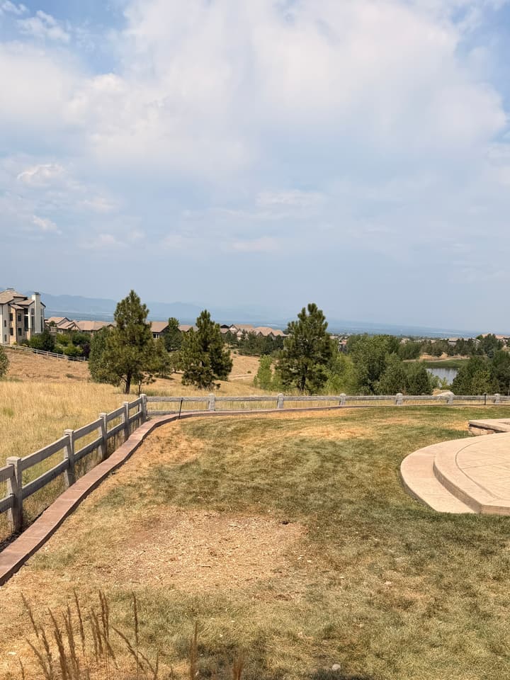 After tree removal and stump grinding in Highlands Ranch, CO: the same yard with the maple and its stump gone and the view open